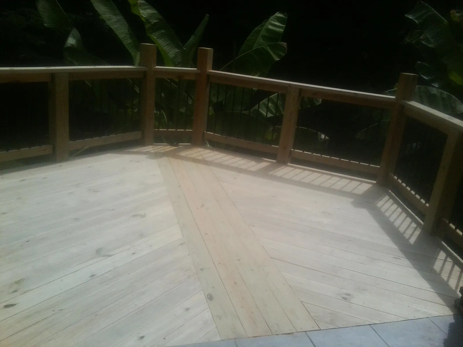 New wood deck and railing built off the back of a home in Mc Kenzie